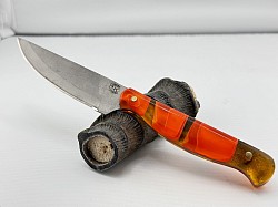 #707 - Nolen neck knife.  Blade length 3 1/2, overall 7 1/2.  Made with 440c.  The handle is orange acrylic handle.  $110.00