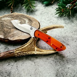 #724 - Nolen small gut hook.  Made with 440c.  Blade length 3, overall 6.75.  The handle material is orange acrylic with red and white spacers next to the blade. $225.00